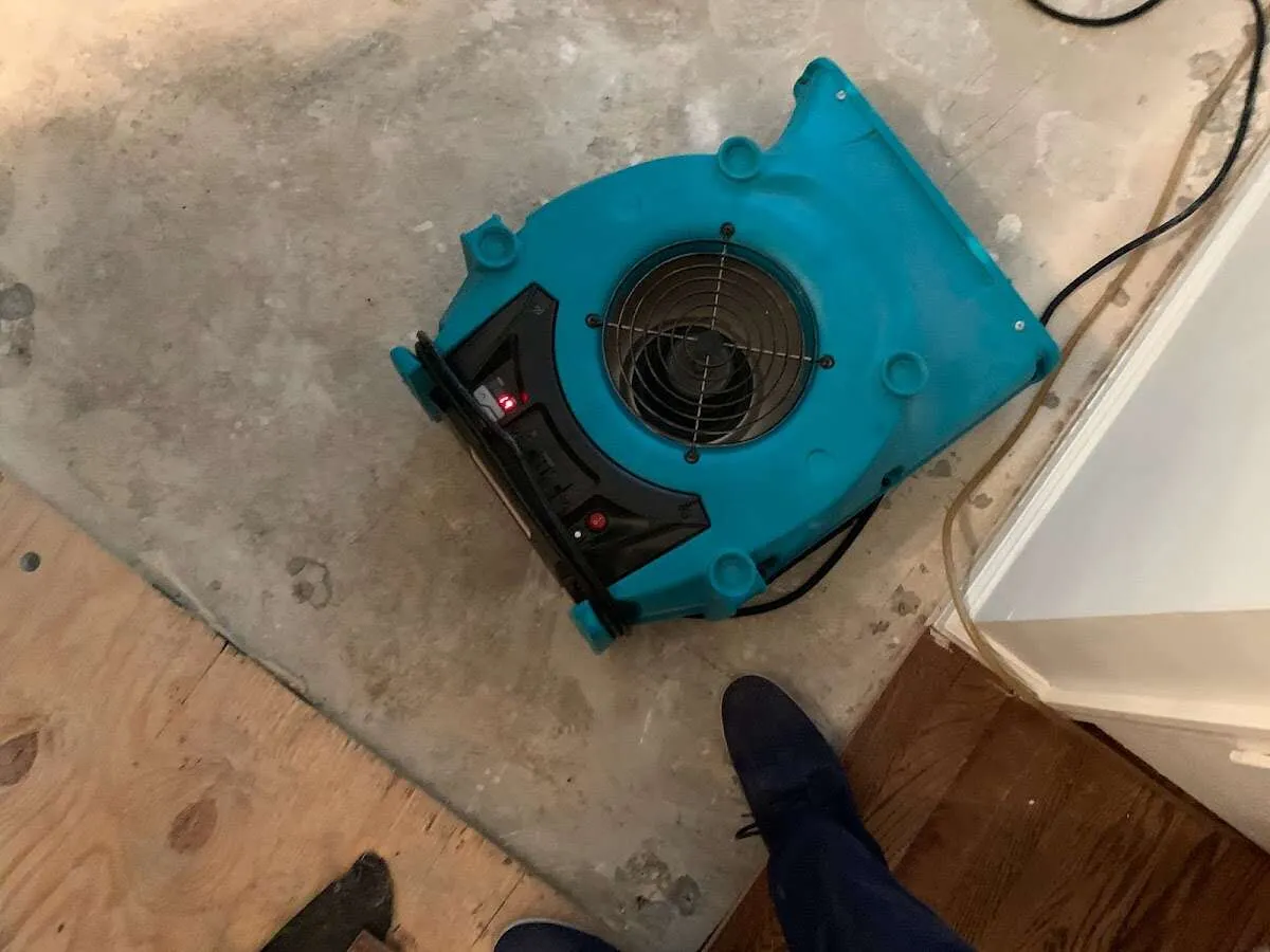 Air mover drying subfloor during Commercial Water Damage Restoration in Rancho Calaveras